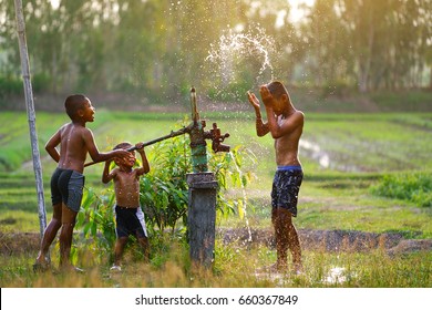 Asian Children Play With The Groundwater Pump,Little Boys In Countryside Vietnamese Vietnam,