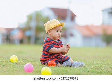 Asian Children Playing Ball In The Middle Of The Lawn