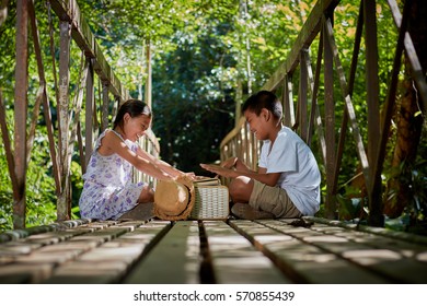 Asian Children playing on the bridge in forest - Shutterstock ID 570855439