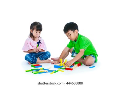 Asian Children Playing Toy Wood Blocks Together. Frustrated Girl Showing Moody Behavior. Isolated On White Background. Educational Toys For Elementary And Kindergarten Child. Studio Shot.