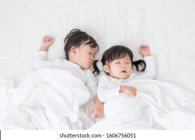 Asian Children Sleeping In Bed