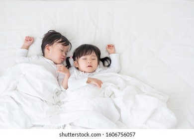 Asian Children Sleeping In Bed