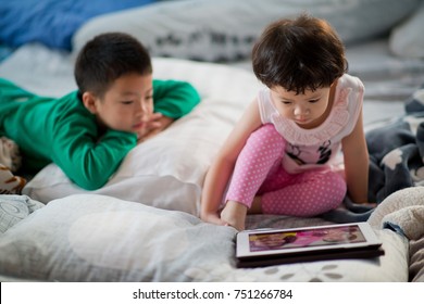 Asian Children Watching Tablet  / Playing Phone And Looking At Cartoon / Kid Play Tablet
