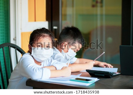 asian children wearing protection mask study at home school