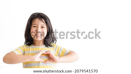 Asian child's hands gesture in heart shape showing love and kindness. Concept of Health care, Charity, Organ Donation, Generous, Pleasure, Hopeful, Love, World heart day.isolated on white background.