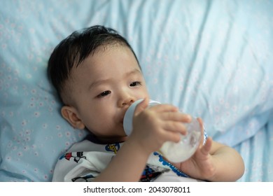 Asian Chinese Baby Boy Holding Milk Bottle Drinking Milk