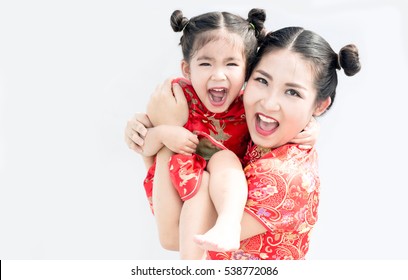 Asian Chinese Daughter And Mother Big Smile And Hug Together Show Happy Family Time In Chinese New Year Festival. Chinese Cheongsam Costume Action On White Background.