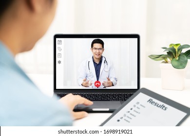 Asian Chinese Doctor Video Conference Call Online Talking For Follow Up Remotely With Medical Coronavirus Result At Home.Online Healthcare Digital Technology Service, Counselor And Interview App.