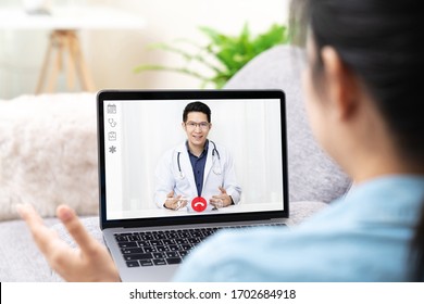 Asian Chinese Doctor Video Conference Call Online Talking For Follow Up Remotely With Medical Coronavirus Result At Home.Online Healthcare Digital Technology Service, Counselor And Interview App.