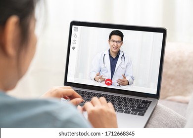 Asian Chinese Doctor Video Conference Call Online Talking For Follow Up Remotely With Medical Coronavirus Result At Home.Online Healthcare Digital Technology Service, Counselor And Interview App.