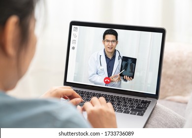 Asian chinese doctor video conference call online talking for follow up remotely with medical coronavirus result at home. Online healthcare digital technology service, counselor and internet support. - Shutterstock ID 1733736089