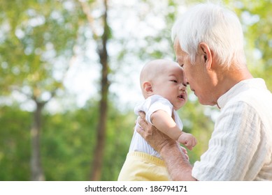 Asian Chinese Grandfather And Grandson Relaxing At Outdoor