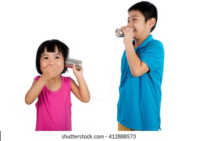 Asian Chinese Kid Playing With Tin Can Phone Isolated On White Background