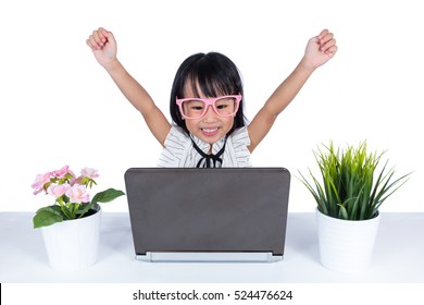 Asian Chinese little girl using laptop with hands up in isolated white background.