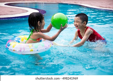 Asian Chinese Little Kids Playing In The Outdoor Swimming Pool