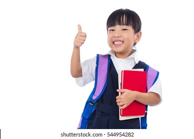 Asian Chinese Little Primary School Girl With School Uniform Showing Thumbs Up In Isolated White Background.