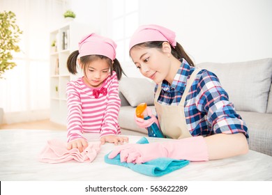 Asian Chinese Mother And Kids Cleaning Room Together. Happy Family Do The Dusting At Home. Housework And Household Concept.