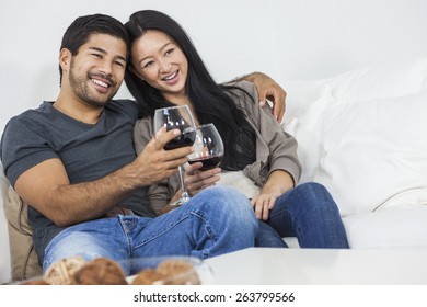 Asian Chinese Romantic Man Woman Couple Drinking Glass Of Red Wine At Home Together