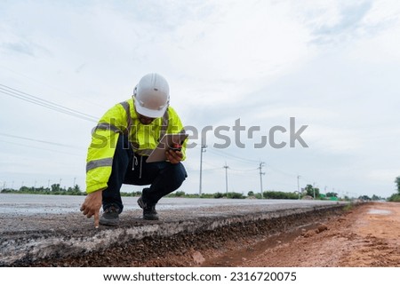 Asian civil engineers inspect roads before construction.
