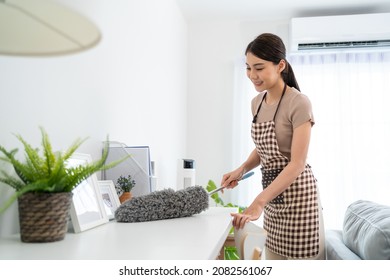 Asian Cleaning Service Woman Worker Cleaning In Living Room At Home. Beautiful Girl Housewife Housekeeper Cleaner Feel Happy And Wiping Messy Dirty Working Table For Housekeeping Housework Or Chores.