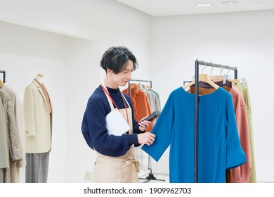 Asian Clothing Shop Staff Checking The Items