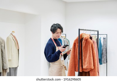 Asian Clothing Shop Staff Checking The Items