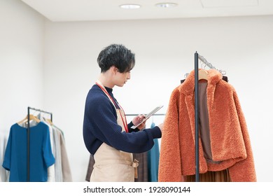 Asian Clothing Shop Staff Checking The Items