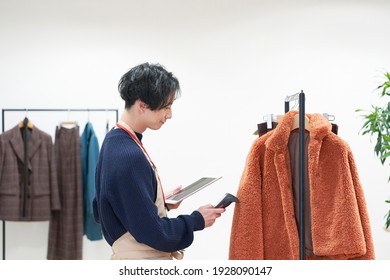 Asian Clothing Shop Staff Checking The Items