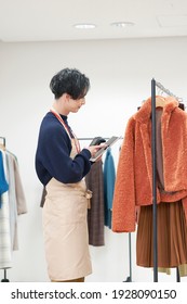 Asian Clothing Shop Staff Checking The Items