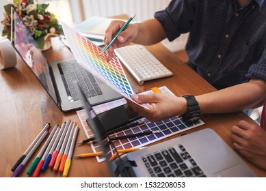 Asian colleagues designer drawing sketches on graphic laptop. Teamwork concept. - Powered by Shutterstock