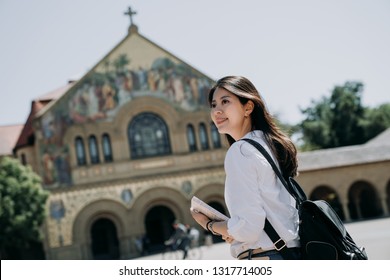 Asian College Girl Carrying Backpack And School Book Walking To Church Praying In The Morning Before Go To Class In University. Smart Woman Study As Exchange Student Program Short Term.