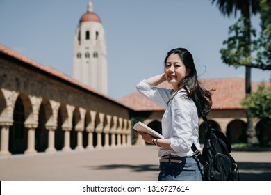 Asian College Girl Standing Outdoor Going To Class At School In Summer Tour Program. Elegant Smart Exchange Student Study Overseas In Stanford Usa. Young Woman Freshman In New Semester Cheerful Smile