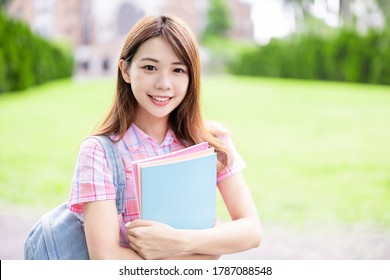 Asian College Student Smile To You With Books Holding In Hands On Campus