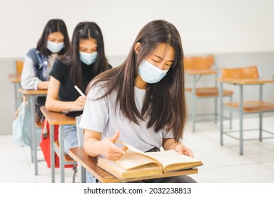 Asian College Students Back To School With Facemask And Keep Social Distance While Study In The Classroom To Prevent COVID-19 Pandemic