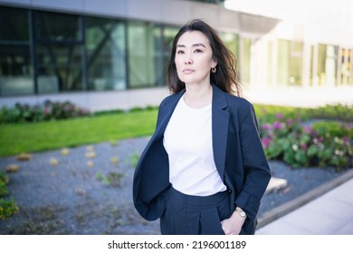 Asian Confident Business Woman In Suit. Bright Future Of Career Opportunities Concept. Job, Work Aspirational Banner, Spring Background Of Office Center. Business People Lifestyle. Copy Space