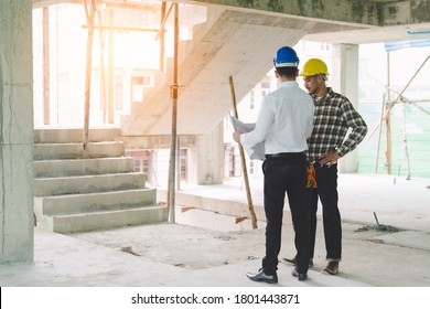 Asian contractor and engineer inspecting material in construction building.