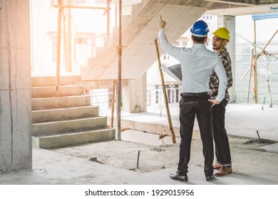 Asian contractor and engineer inspecting material in construction building.