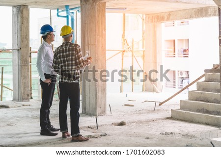 Asian contractor and engineer inspecting material in construction building. Stockfoto © 