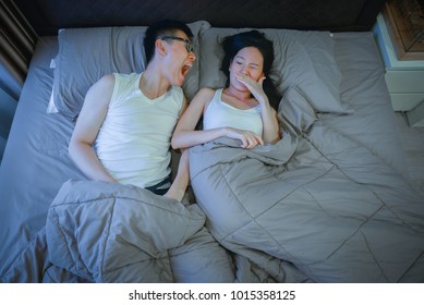 Asian Couple With Bad Breath Issues On Bed At Night