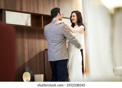 Asian Couple Dancing In Living Room Enjoying Elegant Life Smiling