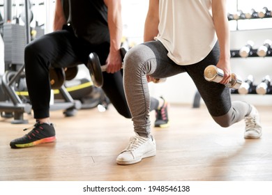 Asian Couple Doing Dumbbell Front Lunge