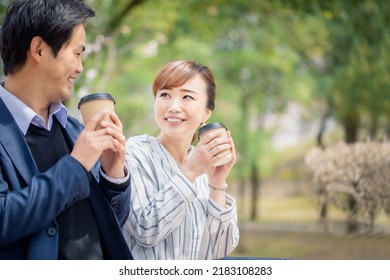 Asian Couple Drinking Coffee Together