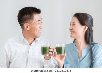 Asian couple drinking green juice - Powered by Shutterstock