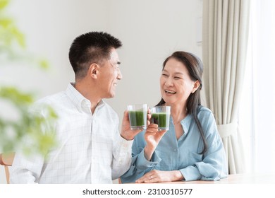 Asian couple drinking green juice - Powered by Shutterstock