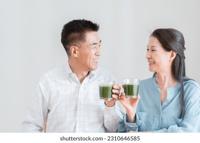 Asian couple drinking green juice - Powered by Shutterstock