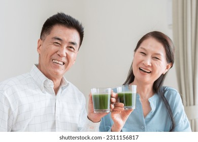 Asian couple drinking green juice - Powered by Shutterstock