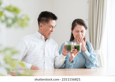 Asian couple drinking green juice - Powered by Shutterstock