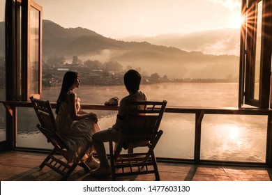 Asian Couple Drinking Tea Sunrise At Lee Wine Rak Thai, Chinese Settlement, Mae Hong Son, Thailand