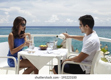 Asian Couple Drinking Wine At The Sea