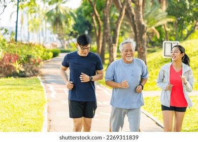 Asian couple with elderly father jogging exercise together at park. Retired old man with outdoor lifestyle sport training workout in the city. Family relationship and senior people health care concept - Powered by Shutterstock